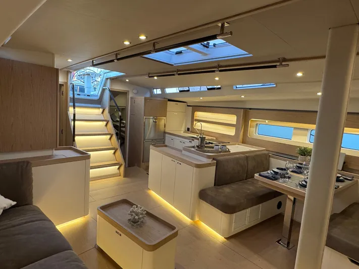  Yacht Photos Pics Luxurious interior of 2023 Beneteau First 53 yacht with modern design and ambient lighting.