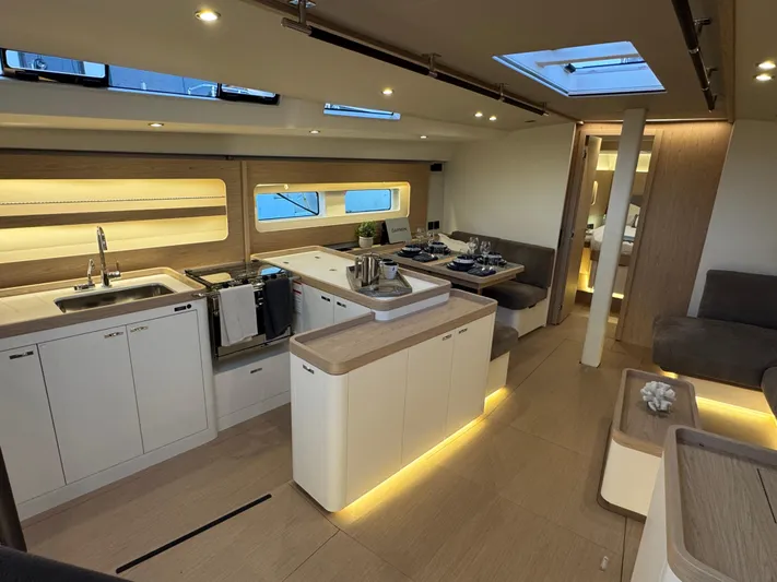  Yacht Photos Pics Luxurious interior of 2023 Beneteau First 53 yacht with modern kitchen and dining area.