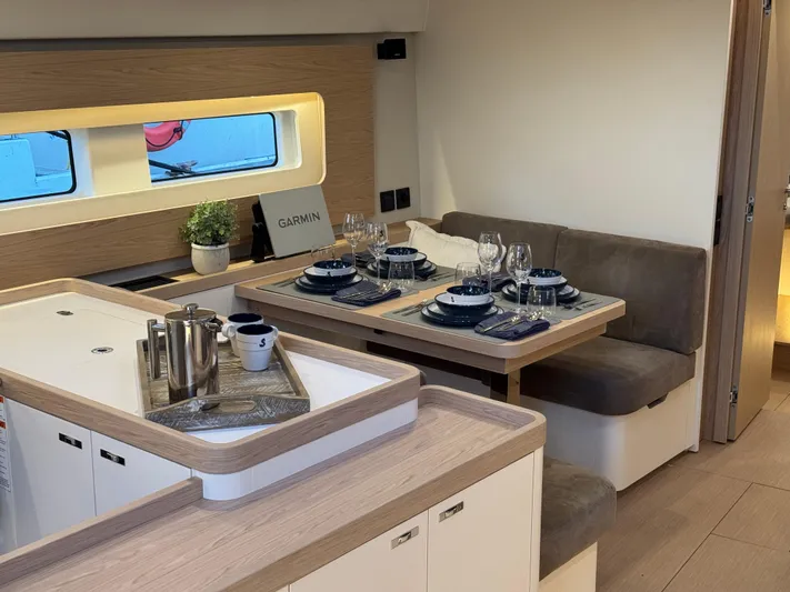  Yacht Photos Pics Luxurious interior of 2023 Beneteau First 53 yacht with elegant dining area.