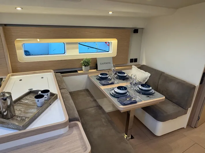  Yacht Photos Pics Luxurious interior of 2023 Beneteau First 53 yacht with elegant dining setup.