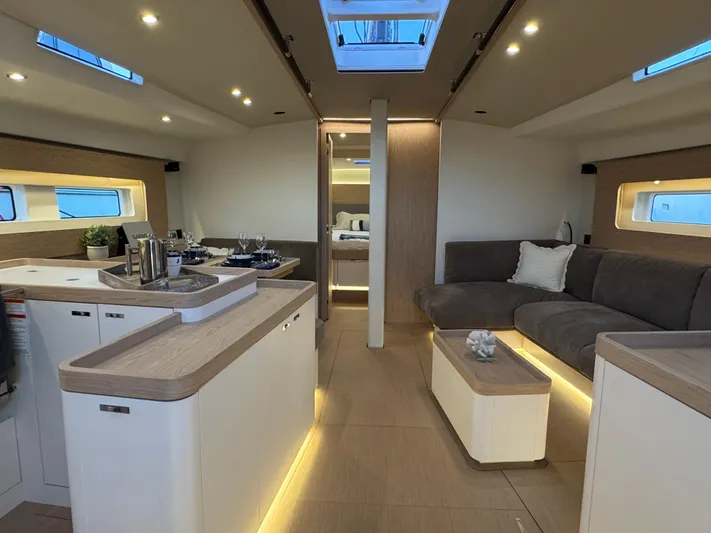  Yacht Photos Pics Luxurious interior of 2023 Beneteau First 53 yacht with modern design and ambient lighting.