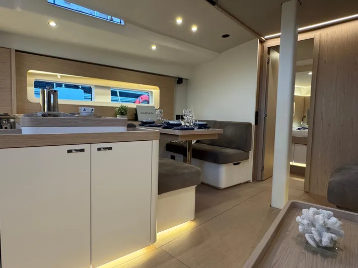  Yacht Photos Pics Luxurious interior of 2023 Beneteau First 53 yacht with modern dining area and elegant decor.