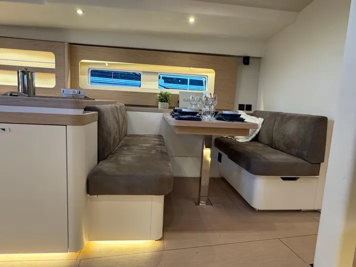  Yacht Photos Pics Luxurious interior of 2023 Beneteau First 53 yacht with elegant dining area.