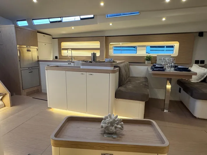  Yacht Photos Pics Luxurious interior of 2023 Beneteau First 53 yacht with modern kitchen and dining area.