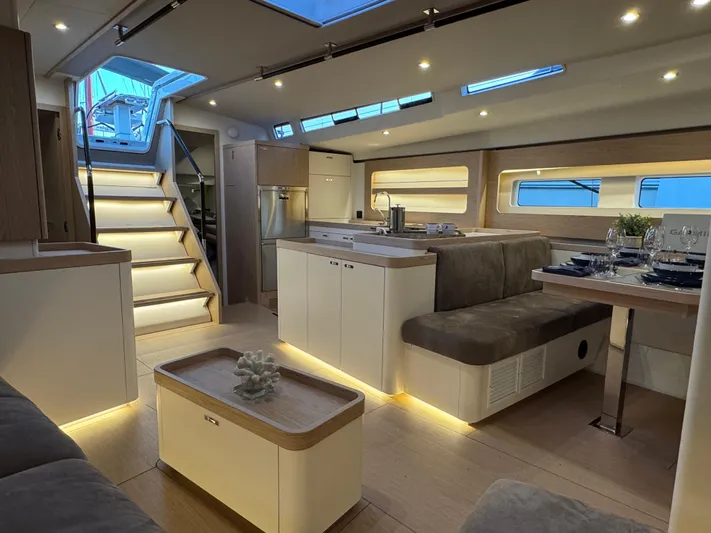  Yacht Photos Pics Luxurious interior of 2023 Beneteau First 53 yacht with modern design and ambient lighting.