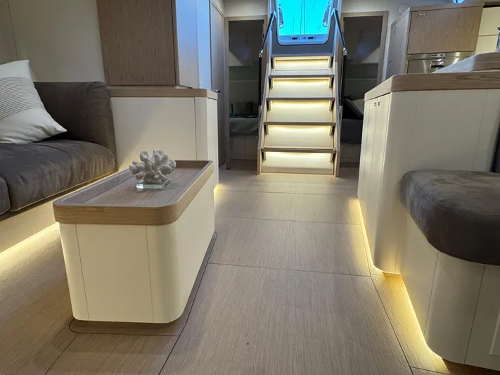  Yacht Photos Pics Luxurious interior of 2023 Beneteau First 53 yacht with modern lighting and elegant furnishings.