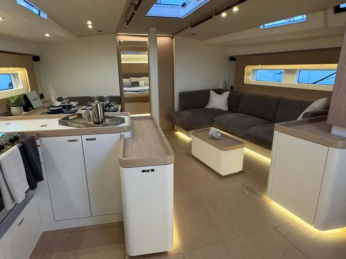  Yacht Photos Pics Luxurious interior of 2023 Beneteau First 53 yacht with modern design and ambient lighting.