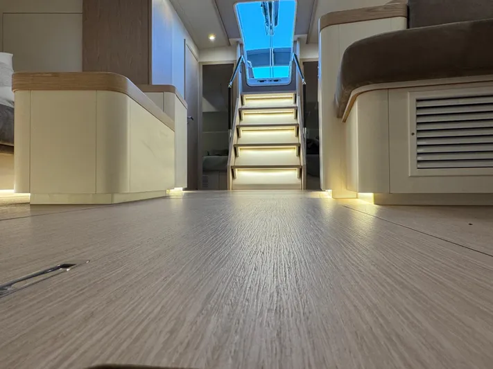  Yacht Photos Pics Interior of 2023 Beneteau First 53 yacht, featuring modern design and ambient lighting.