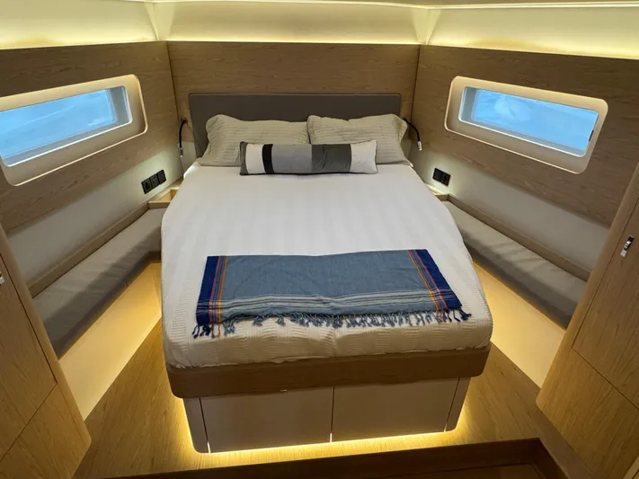  Yacht Photos Pics Luxurious bedroom interior of 2023 Beneteau First 53 yacht with modern design.