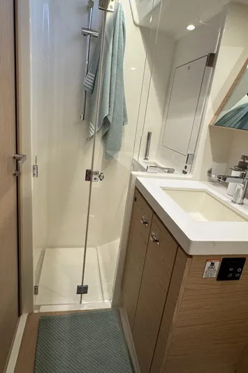  Yacht Photos Pics Modern bathroom in 2023 Beneteau First 53 yacht with shower and sink.