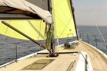  Yacht Photos Pics 2023 Beneteau First 53 sailboat with yellow sails on open sea.