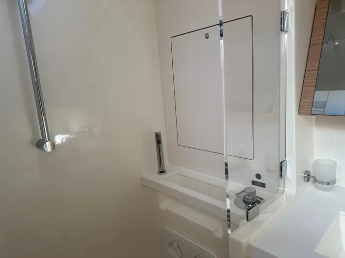  Yacht Photos Pics 2023 Beneteau First 53 yacht bathroom with modern fixtures and sleek design.