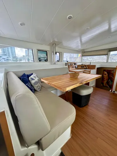  Yacht Photos Pics Interior of 2010 Lagoon 400 yacht with wooden table and beige seating.