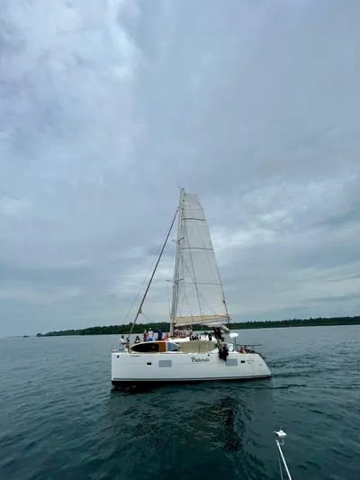  Yacht Photos Pics 2010 Lagoon 400 catamaran sailing on calm waters under a cloudy sky.