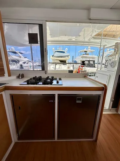  Yacht Photos Pics Interior view of a 2010 Lagoon 400 yacht kitchen with stove and marina view.