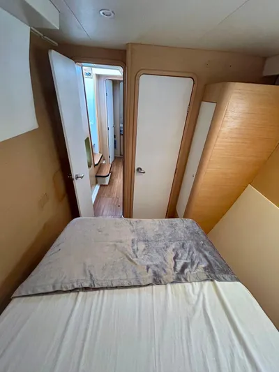  Yacht Photos Pics Interior cabin of a 2010 Lagoon 400 catamaran with bed and wooden furnishings.