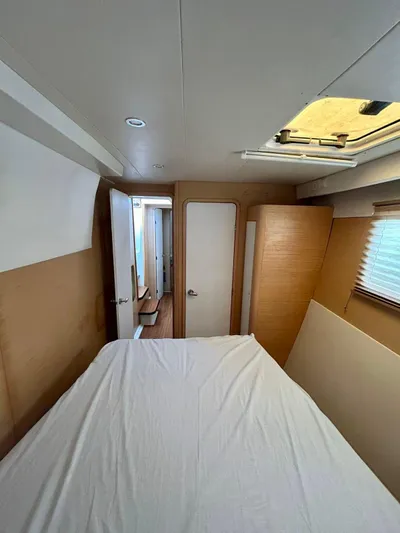  Yacht Photos Pics Interior cabin of 2010 Lagoon 400 catamaran with bed, skylight, and wooden accents.