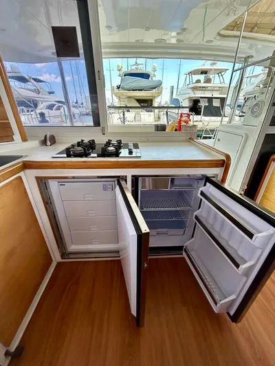  Yacht Photos Pics Interior of 2010 Lagoon 400 yacht kitchen with open fridge and stove.