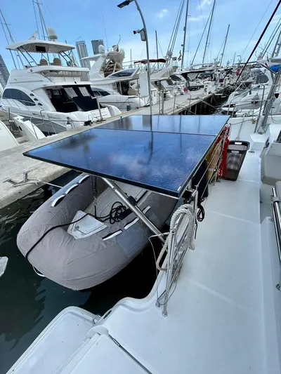  Yacht Photos Pics Lagoon 400 catamaran (2010) docked, featuring solar panels and an inflatable dinghy.