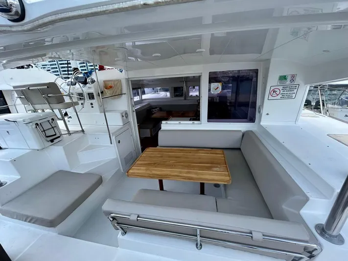  Yacht Photos Pics Spacious 2010 Lagoon 400 catamaran cockpit with seating and wooden table.