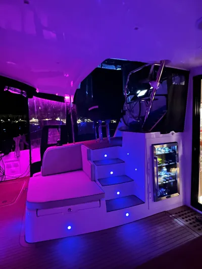  Yacht Photos Pics Luxurious 2023 Lagoon 42 yacht interior with ambient purple lighting and modern design.