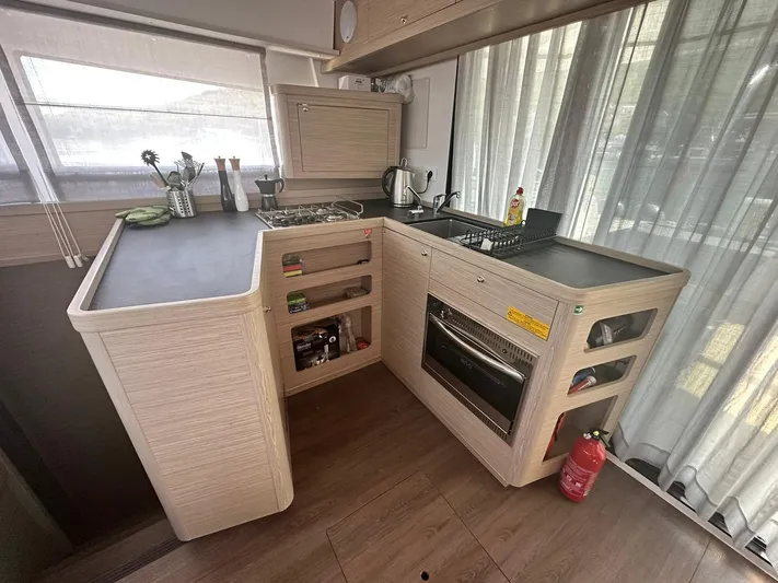  Yacht Photos Pics Modern kitchen in 2023 Lagoon 42 yacht with sleek countertops and appliances.