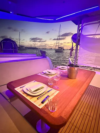  Yacht Photos Pics Luxurious dining setup on Lagoon 42 yacht at sunset, 2023 model.