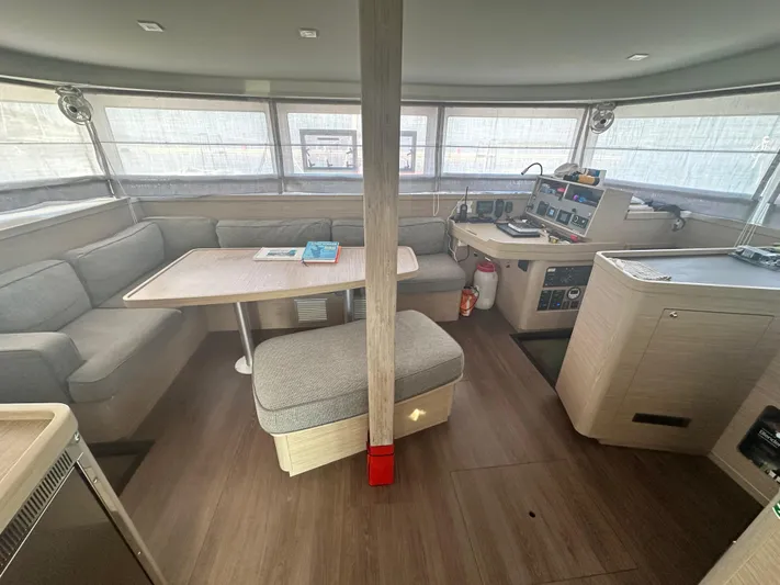  Yacht Photos Pics Interior of 2023 Lagoon 42 catamaran with modern seating and navigation area.