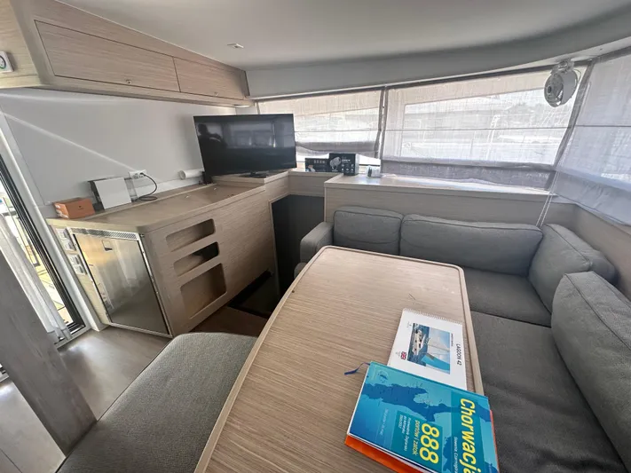  Yacht Photos Pics Interior of 2023 Lagoon 42 yacht with modern seating, table, and navigation equipment.