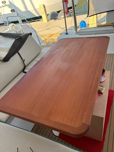  Yacht Photos Pics Polished wooden table on 2023 Lagoon 42 yacht deck.