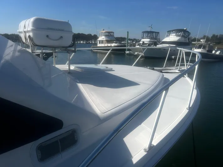  Yacht Photos Pics 2002 Cabo 35 Flybridge yacht docked in marina, sunny day.