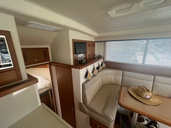  Yacht Photos Pics Interior of 2002 Cabo 35 Flybridge with seating area and table.