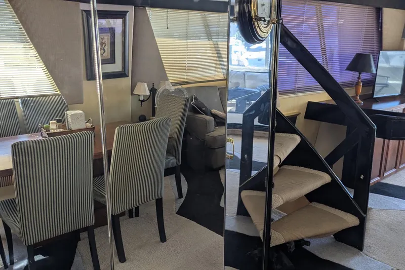  Yacht Photos Pics Interior of 1992 Viking 65 Motor Yacht with elegant dining area and spiral staircase.