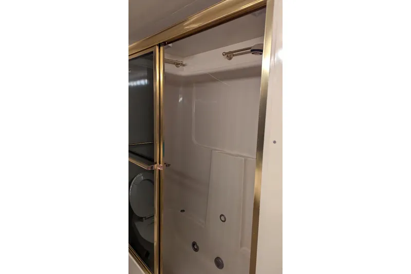  Yacht Photos Pics Shower area in 1992 Viking 65 Motor Yacht with gold trim.