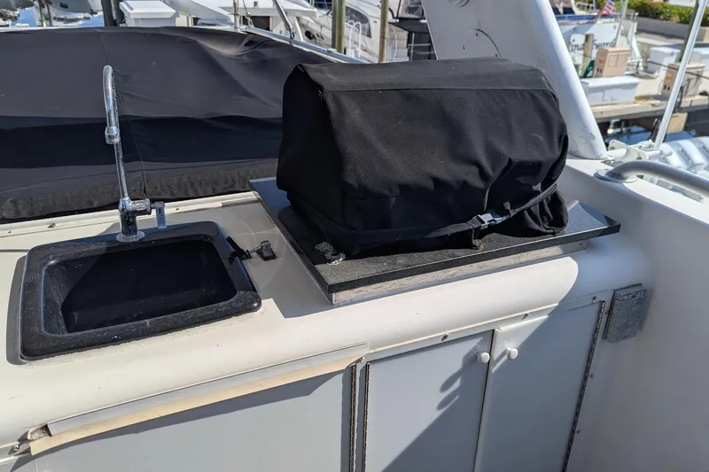  Yacht Photos Pics Outdoor sink and covered grill on 1992 Viking 65 Motor Yacht deck.