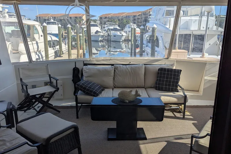  Yacht Photos Pics Interior of 1992 Viking 65 Motor Yacht with comfortable seating and marina view.