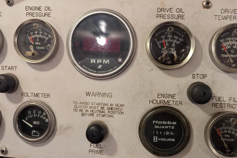  Yacht Photos Pics Control panel of a 1992 Viking 65 Motor Yacht with gauges and warning labels.