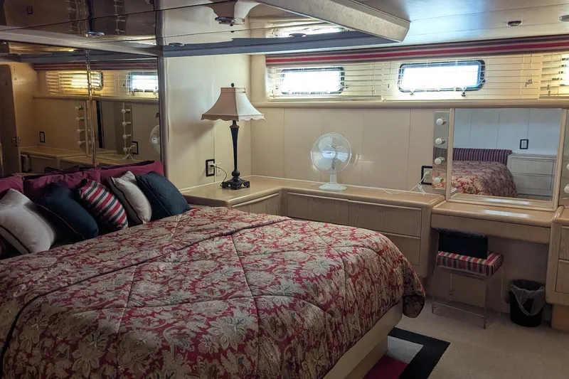  Yacht Photos Pics Luxurious bedroom interior of 1992 Viking 65 Motor Yacht with elegant decor and cozy bedding.