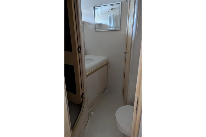  Yacht Photos Pics Bathroom interior of 1992 Viking 65 Motor Yacht, featuring sink and toilet.