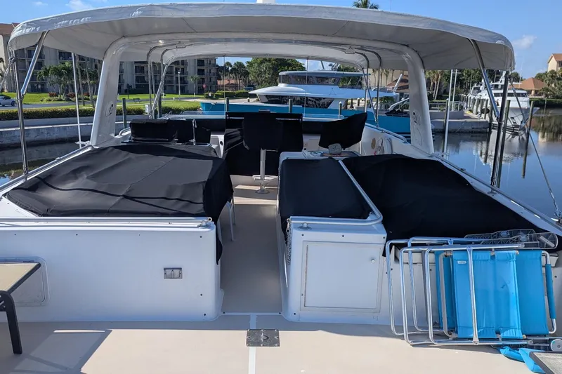  Yacht Photos Pics 1992 Viking 65 Motor Yacht with covered seating, docked in a marina.