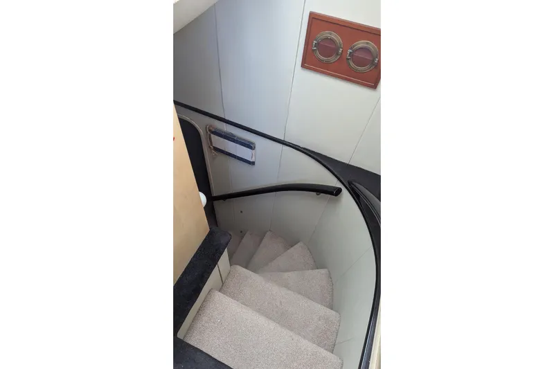  Yacht Photos Pics Staircase inside 1992 Viking 65 Motor Yacht with carpeted steps and wooden accents.