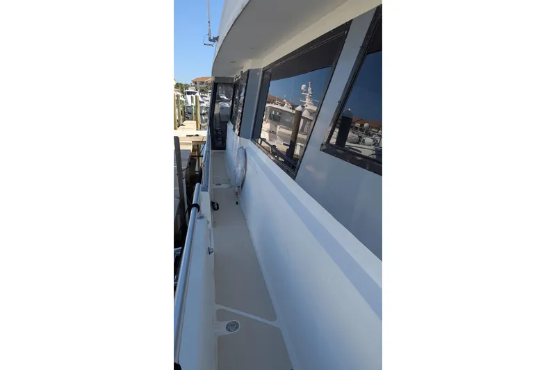  Yacht Photos Pics Side deck of 1992 Viking 65 Motor Yacht, featuring sleek design and reflective windows.