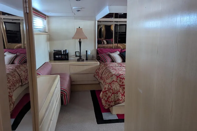  Yacht Photos Pics Luxurious bedroom interior of 1992 Viking 65 Motor Yacht with elegant decor and furnishings.