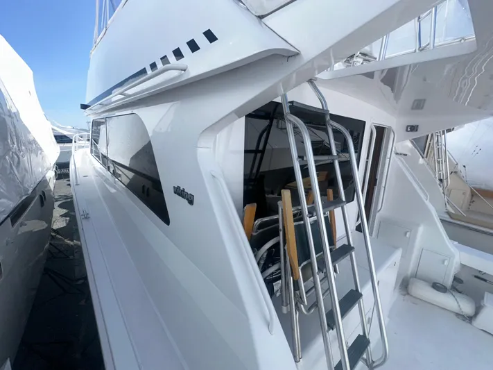  Yacht Photos Pics 1998 Viking 53 Convertible yacht with sleek design and ladder access.