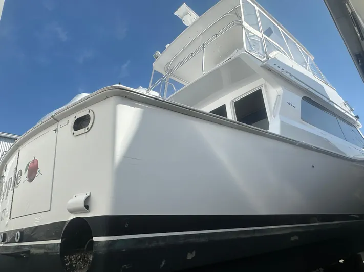 Yacht Photos Pics 1998 Viking 53 Convertible yacht, white exterior, docked under clear blue sky.