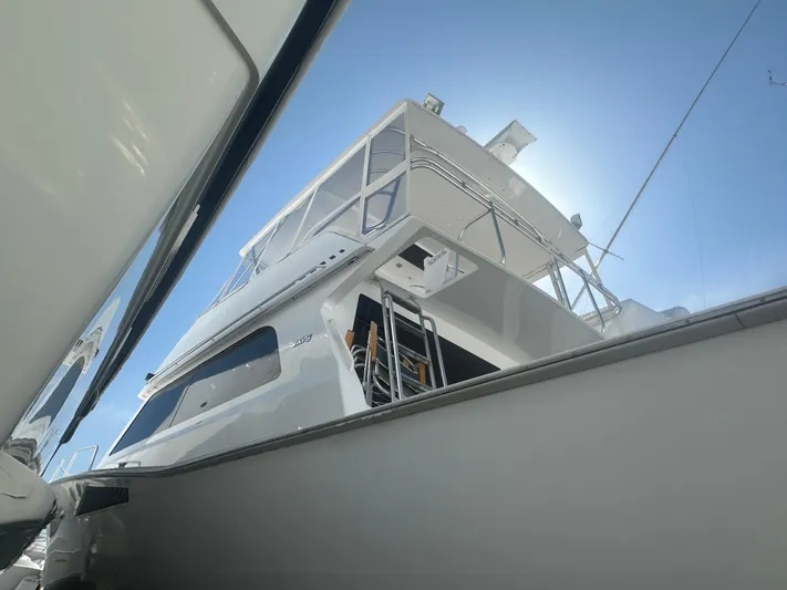  Yacht Photos Pics 1998 Viking 53 Convertible yacht viewed from below against a clear blue sky.