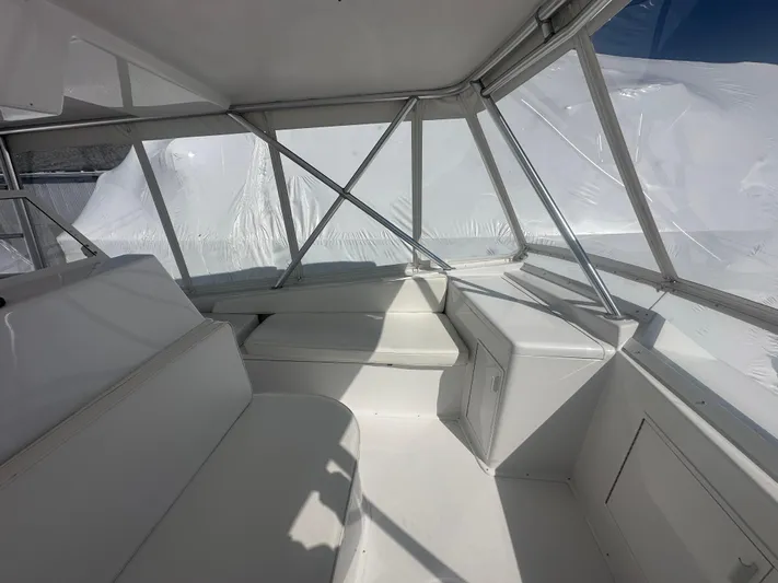  Yacht Photos Pics 1998 Viking 53 Convertible yacht interior with white seating and clear windows.