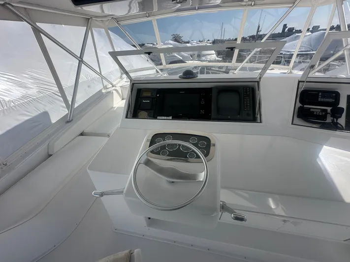  Yacht Photos Pics 1998 Viking 53 Convertible yacht helm with steering wheel and navigation equipment.