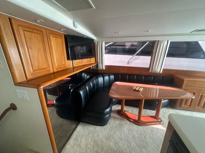  Yacht Photos Pics Luxurious interior of a 1998 Viking 53 Convertible yacht with leather seating and wooden cabinetry.