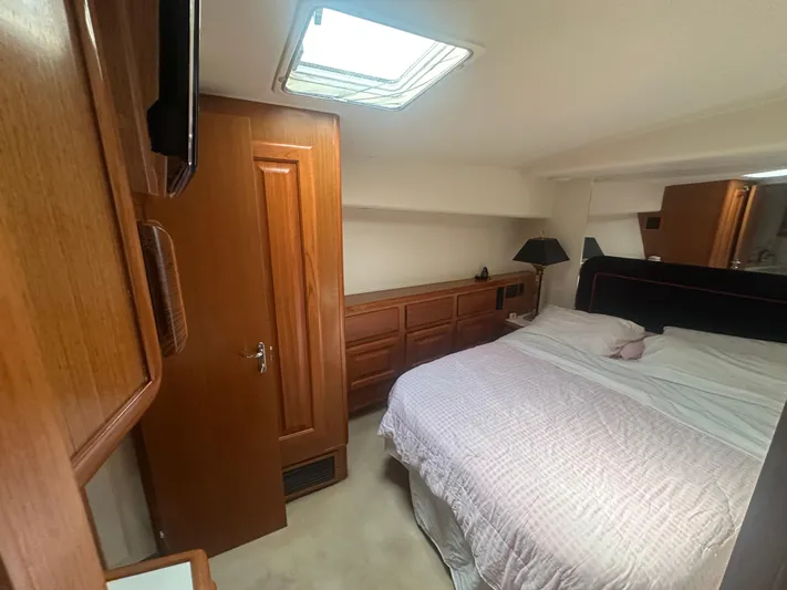  Yacht Photos Pics Cozy bedroom in 1998 Viking 53 Convertible yacht with wooden cabinetry and skylight.